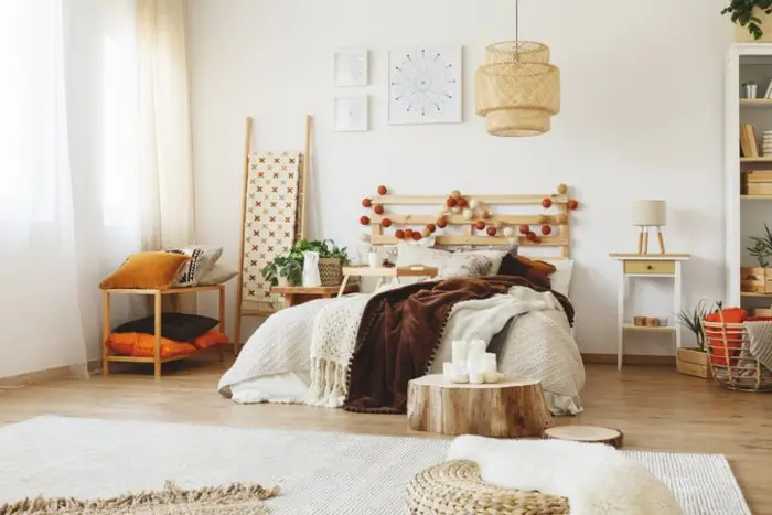 Cozy bed with modern design in a comfy, well-lit bedroom for hygge comfort